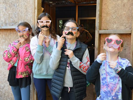 CJDS students posing with fake glasses and mustaches
