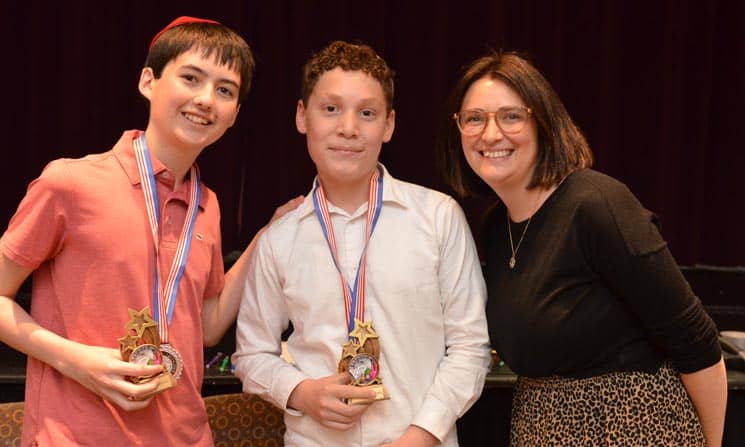 science-fair-ms-pages CJDS Middle School students holding medals with teacher